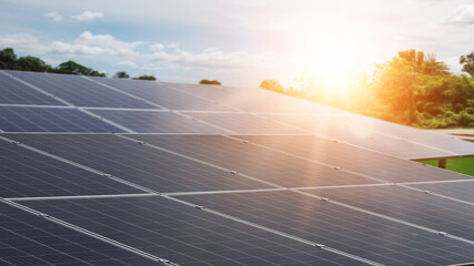 Solar energy panels and sunlight at sunset. Concept of sustainable resources.