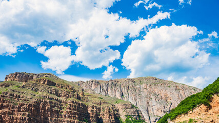 High majestic cliffs and blue sky with clouds