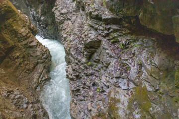 Klamm in den Alpen mit klarem Wasser und Wasserfall