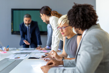 Group of coworkers working together on business project in modern office
