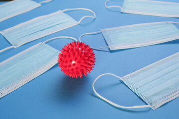 Viral Coronavirus Bacteria And Protective Medical Disposable Masks On A Blue Background. Concept Of...