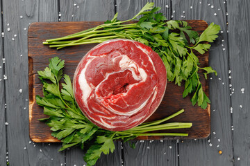 Raw beef fillet steaks on black wooden table
