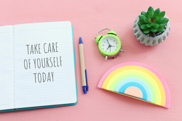 self care concept. notebook with text over pink background