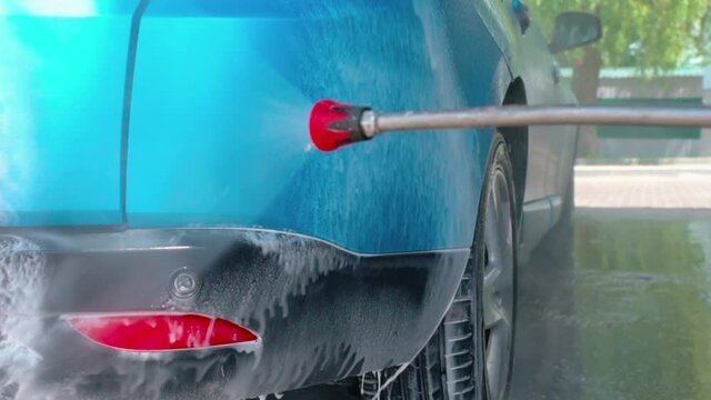 Car washing. Cleaning car with contactless high pressure washing. Self wash station