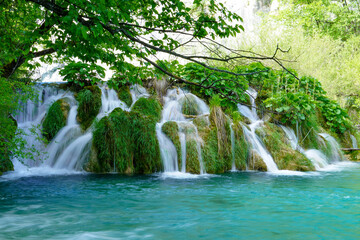 Plitvice Lakes National Park waterfall landscape with turquoise blue and green water in Croatia.
