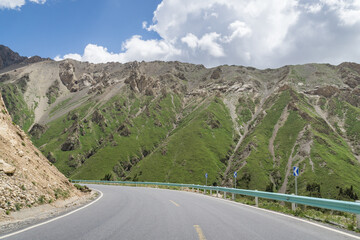 Highways with mountains and grasslands in Xinjiang, China in summer