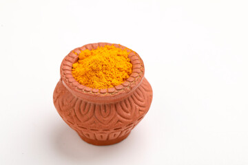 Turmeric powder in clay bowl.