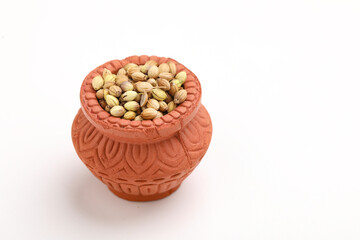 coriander seed in clay bowl on white background.
