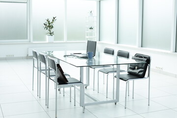 Laptop medical stethoscope coffee cup phone day planner on glass table in office space