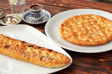 Baked homemade flatbread on wooden background close up