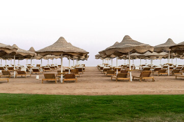 sun loungers and umbrellas on a beach in Egypt