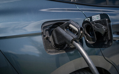 Electric Car on a charging station with back and light plug detail, electric mobility. Modern...