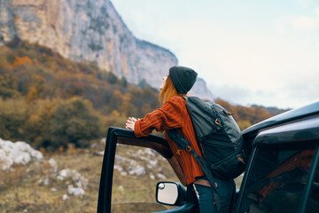 woman hiker near car in mountains trip travel adventure