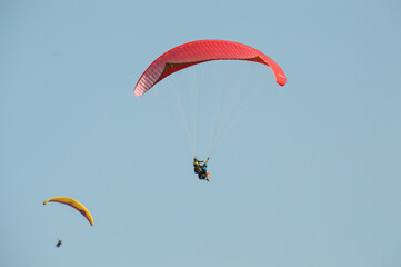 Two paragliders against the blue sky