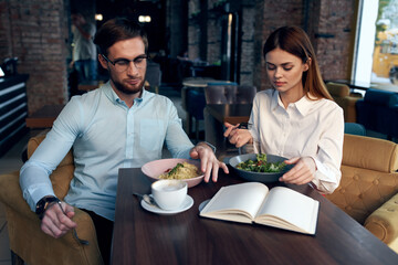 business men and women sit at the table with the phone chatting breakfast