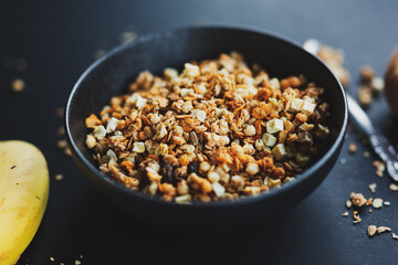 Homemade granola in bowl on dark