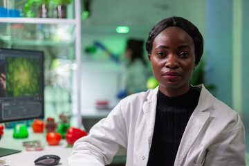 Closeup of african biologist woman looking into camera while working in biological agronomy...