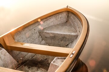 Small boat on a tranquil water of Rynskie lake in Ryn, Poland. Masurian Lake District.