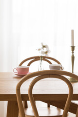 Pink empty coffee cup on wooden table.