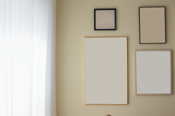 mockup of blank three frame poster on the wall.