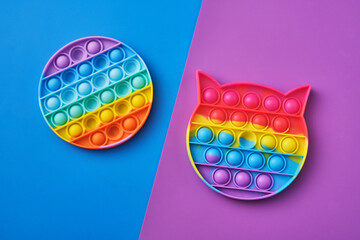 Bright rainbow toy antistress for children and adults on a colorful background. New popular...