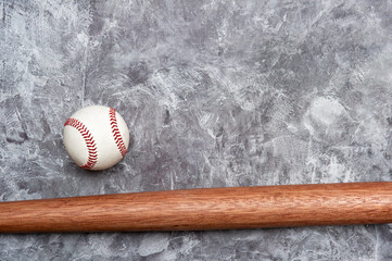Baseball ball and bat on grey background. Team sport concept