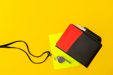 Football soccer referee equipment on yellow background. Top view, space for your text. Sport concept