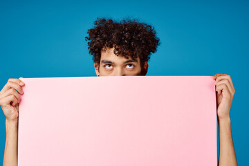 guy with curly hair holding pink Poster mockup Coffee Space