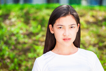 Portrait of a young beautiful girl in summer park