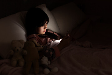 Girl using cell phone in bed