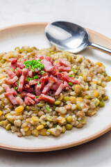 porridge of legumes with fried bacon and chive