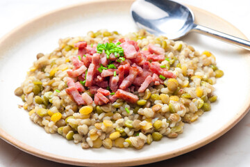 porridge of legumes with fried bacon and chive