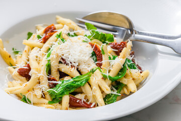 pasta with dry tomatoes and spinach - obrazy, fototapety, plakaty