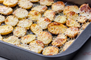 slices of potatoes baked with grated cheese
