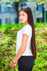 Portrait of a young beautiful girl in summer park