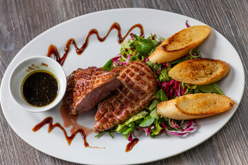 grilled duck breast with honey sauce and salad