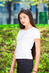 Fototapeta premium Portrait of a young beautiful girl in summer park