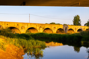 Fototapeta na wymiar Old stone bridge over Vitek pond near Trebon, Southern Bohemia, Czech Republic