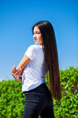 Portrait of a young beautiful girl in summer park