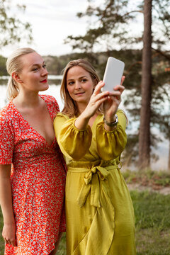 Female friends taking selfie with smart phone