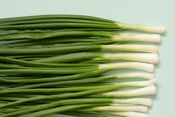 fresh green onions on an azure background