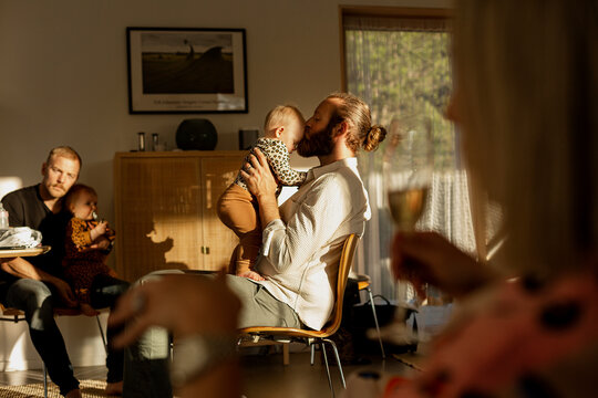 Fathers with their babies resting in living room