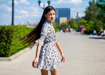 Portrait of a young beautiful girl in summer park