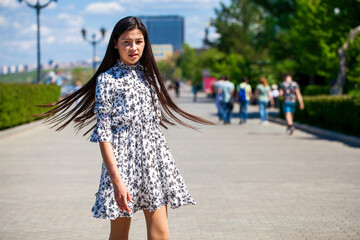 Portrait of a young beautiful girl in summer park
