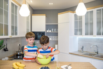 happy family funny kids are preparing the dough, bake cookies in the kitchen