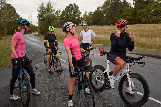 Cyclists relaxing on roadside
