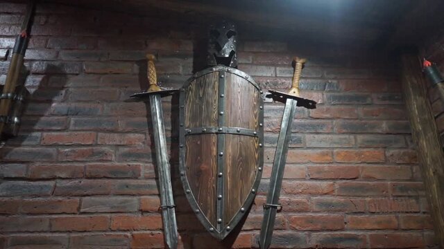 decoration of the medieval castle wall, weapons sword and shield hanging on the wall, decorations and interiors
