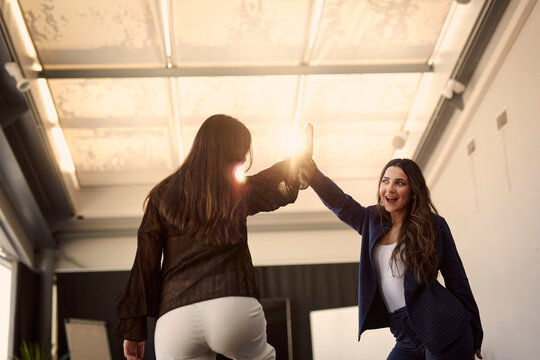 Happy female coworkers in boardroom