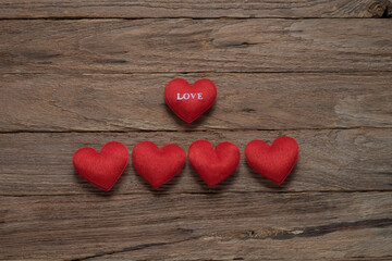 red hearts placed on old wooden floor