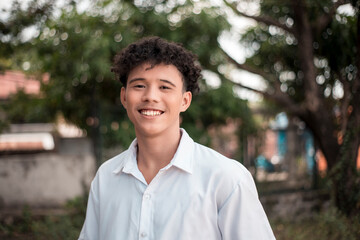 A happy Filipino-African college student. Handsome biracial young man with a great smile outdoors. - Powered by Adobe